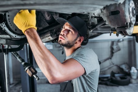 car mechanic under the vehicle